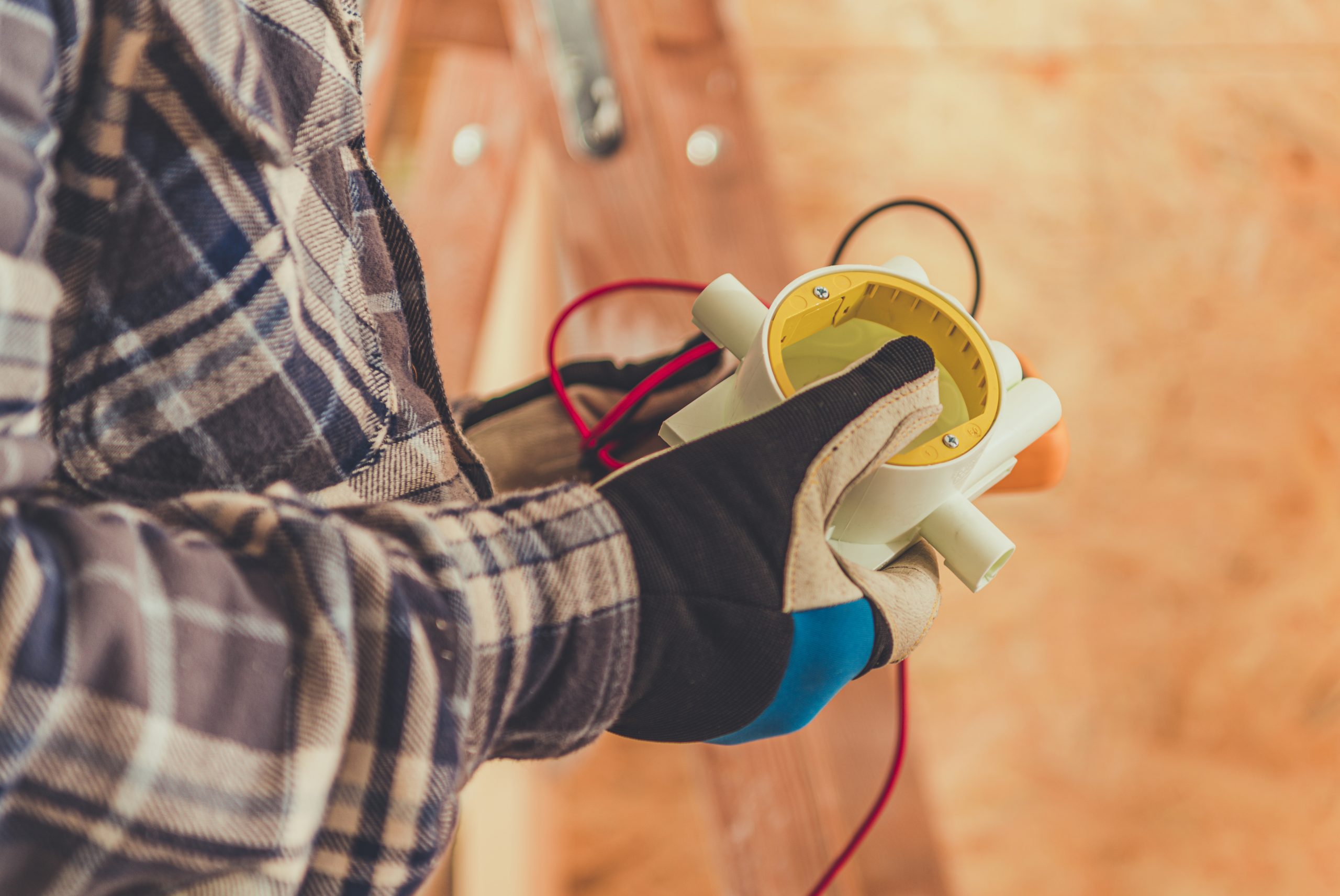 technician measures electrical current with a multimeter in a construction setting during daylight hours photo
